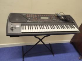 Casio CTK-711 electric keyboard with stand.