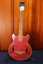 Daisy Rock electric six string guitar with red glitter design, with stand