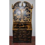 Chinoiserie black lacquered bureau bookcase, the top section with two doors enclosing red