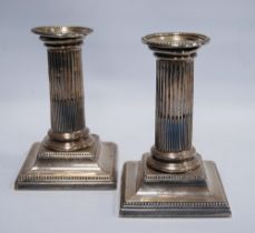 Pair of silver dwarf candlesticks with fluted columns, Sheffield 1889, loaded, 12.5cm.