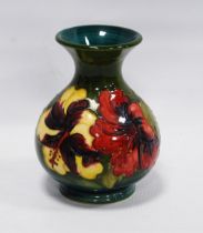 Moorcroft 'Anemone' vase with tube lined decoration on a green ground, bears label to the lower