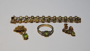 Peridot suite comprising a collet-set bracelet, a ring, a pendant and necklet, and a pair of