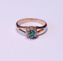 Diamond and emerald cluster ring on bifurcated gold band, size M.