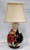 Moorcroft 'Anemone' table lamp with tube lined decoration on a white ground, backstamp to the