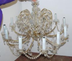 Venetian-style glass chandelier with twelve scroll branches, decorated with pans, garlands and