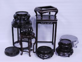 Group of antique and later Chinese and Oriental hardwood vase stands, to include padouk and ebonised