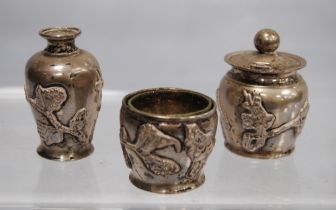 Chinese silver three-piece condiment set, typically embossed.