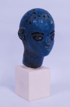 Egyptian coffin head, possibly New Kingdom period, painted in pigment sapphire blue on clay, 11cm
