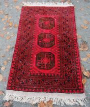 Afghan Belouch hand-knotted rug with three large geometric guls to the centre and further