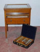 Vintage oak optician's cabinet with glazed viewing top enclosing lenses in fitted compartments above