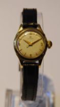 Omega lady's wristwatch in stainless steel case with gold plated bezel, silvered dial, gold-coloured