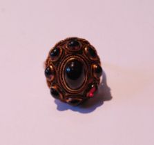 Gold ring with nine oval cabochon garnets, in gold, size Q, 8.5g gross.