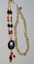 Baroque pearl necklet and a necklace with coral and onyx.