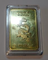 Bank of China 999 gold ingot with raised five claw dragon to the obverse flanked by character marks,