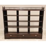 An Edwardian mahogany open bookcase, the top shelf with a spindled gallery over four further shelves