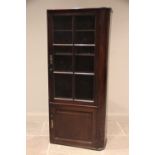 A 19th century mahogany freestanding bookcase, rounded to the right hand side, the single glazed