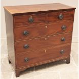 An early 19th century mahogany chest of drawers, the rectangular satinwood cross banded top above an