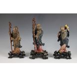 Three Fuzhou lacquer figures of Sanxing, 20th century, comprising Fu, 25.5cm high, Lu, 21.5cm high