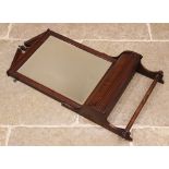 An Edwardian walnut framed toilet mirror, the bevelled rectangular mirror plate below an