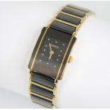 A lady's Rado DiaStar wristwatch, the rectangular lack dial with gold toned dot markers, set to