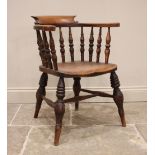 A Victorian elm smokers bow elbow chair, the horse shoe shaped top rail raised upon ring turned