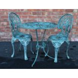 A painted metal patio table and two chairs, 20th century, each chair with a cast foliate open work