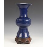 A Chinese porcelain blue monochrome Gu vase, Wanli six-character mark, of typical form with ribbed