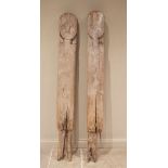 A pair of Indonesian Loro Blonyo gate posts, early 20th century, the weathered and gnarled timber