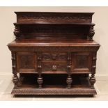 A Victorian carved oak buffet, the superstructure back with carved foliate detail and inverted shelf