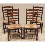 A set of four ash ladder back kitchen chairs, 19th century, each with four shaped rungs over an