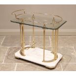 A 'Hollywood Regency' style drinks trolley, mid 20th century, the bevelled and canted glass top