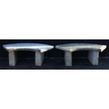 A pair reconstituted stone benches, each of crescent form raised upon rectangular pillar supports,