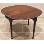 A George III mahogany drop leaf table, possibly Irish, the moulded oval top with a lunette carved