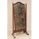 A Regency style mahogany cheval mirror, the rectangular arched mirror plate with bevelled glass,