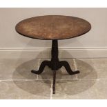 A George III oak tripod table, the circular top raised upon a ring turned baluster column