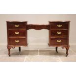 An early 20th century mahogany dressing table/desk, the kidney shaped skiver inset desk top