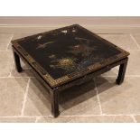 A Japanese black lacquer coffee table, late 20th century, the table top detailed in gilt with exotic