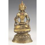 A South East Asian gilt bronze model of Buddha, 19th century, modelled seated in dhyanasana on a