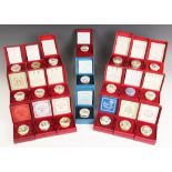 A collection of twenty one Halcyon Days Bilston enamel Christmas boxes, covering the years 1973 to
