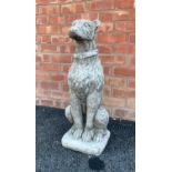 A reconstituted garden figure of an Irish Wolf hound, modelled seated, 74cm high