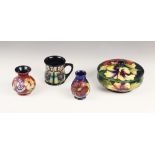 A Moorcroft bowl and cover in the Hibiscus pattern on a green ground, mid 20th century, impressed