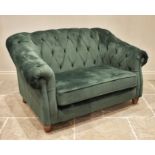 A green velour two seater Chesterfield settee, contemporary, the deep set arms and button back