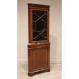 An Edwardian mahogany and satinwood crossbanded freestanding corner display cabinet, with a