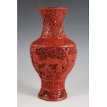 A Chinese cinnabar lacquer vase, late 19th century, of baluster form and extensively carved with