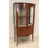 An Edwardian mahogany bowfront display cabinet, the frieze inlaid with an Adam style urn and