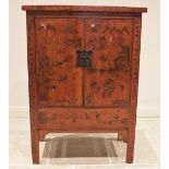 A red lacquer Chinese wedding cabinet, 20th century, probably elm, the twin doors adorned with