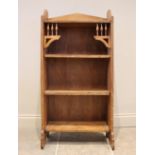 An Arts & Crafts oak bookcase, in the manner of Archibald Knox for Liberty, the open front