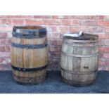 An oak barrel, of typical swelling coopered form with detachable cover, 64cm high, along with a