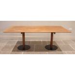 A mid 20th century teak twin pedestal dining table, probably Italian, the rectangular top with