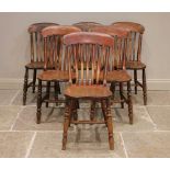 A well matched set of six Victorian elm and ash kitchen chairs, each with a serpentine lath back